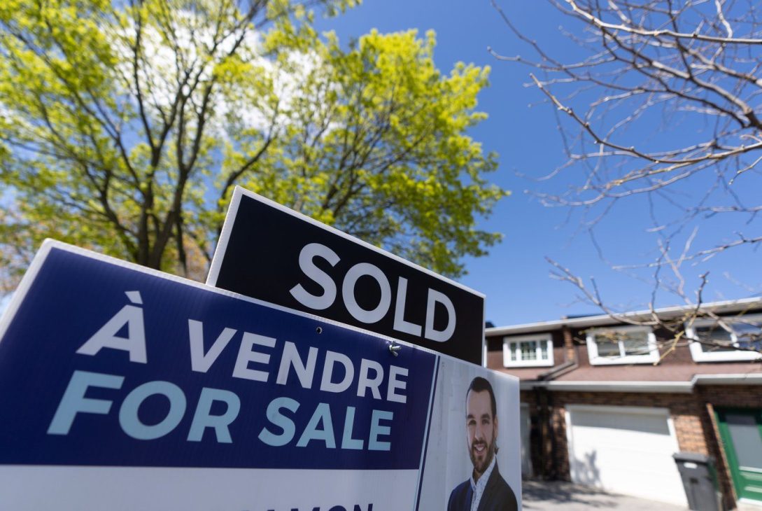 A real estate sign is posted outside a home in Pointe-Claire, a city in Montreal's West Island on May 7, 2024. THE CANADIAN PRESS/Christinne Muschi